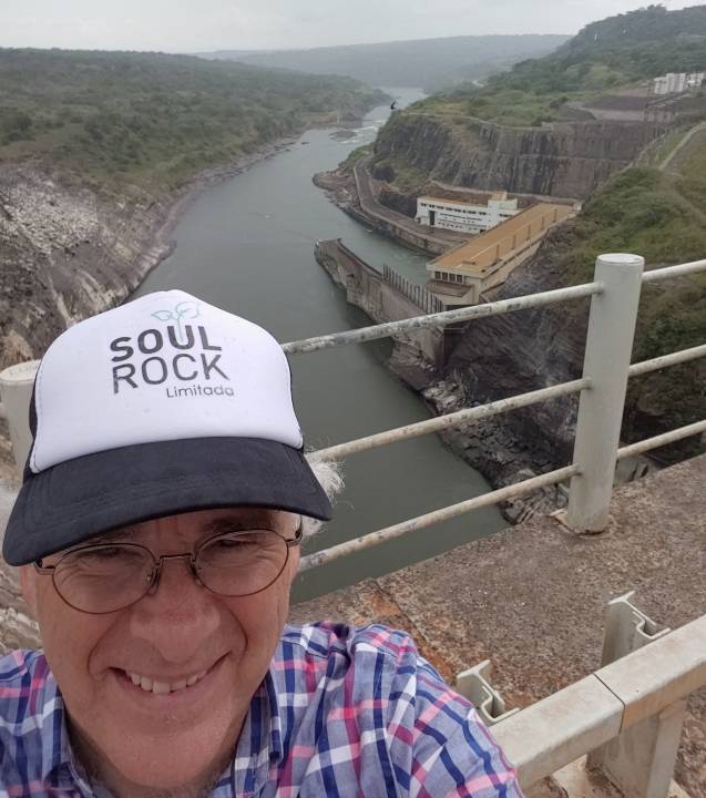 CEO Lindsay Reed on the Capanda Dam Wall with hydroelectric power station downstream